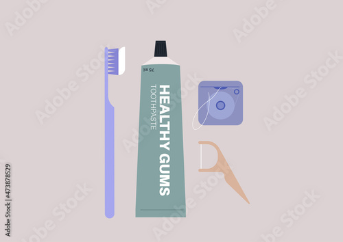 A set of dental hygiene products, a tube of toothpaste, a toothbrush, a dental floss, and a flosser