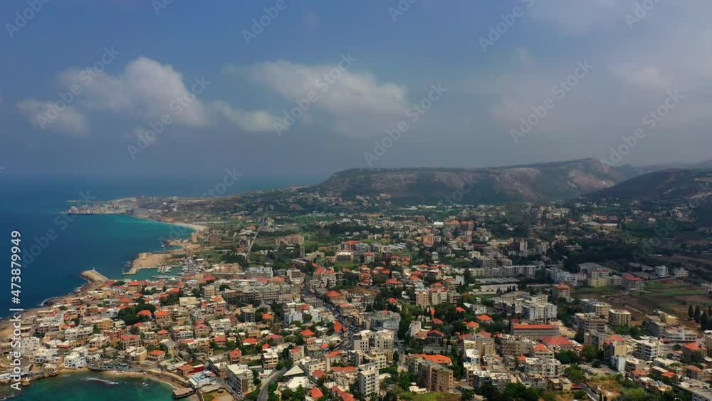 Aerial Panning Beautiful Shot Of Sea Against Cloudy Sky, Drone Flying Over Residential Buildings - Batroun, Lebanon Aerial Panning Beautiful Shot Of Sea Against Cloudy Sky, Drone Flying Over Residential Buildings - Batroun, Lebanon