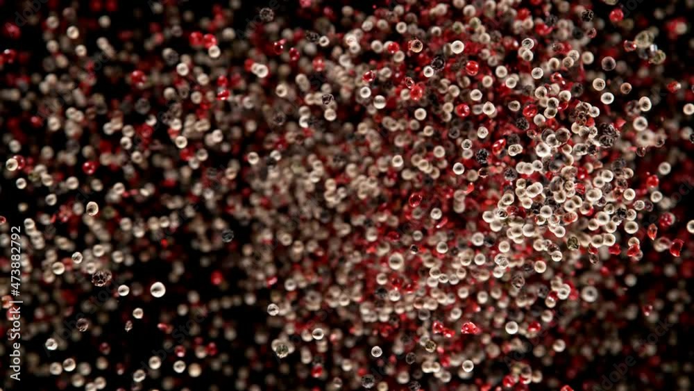 Super slow motion of flying dry whole pepper spice on black. Filmed on high speed cinema camera, 1000 fps. Speed ramp effect. Super slow motion of flying dry whole pepper spice on black. Filmed on high speed cinema camera, 1000 fps. Speed ramp effect.