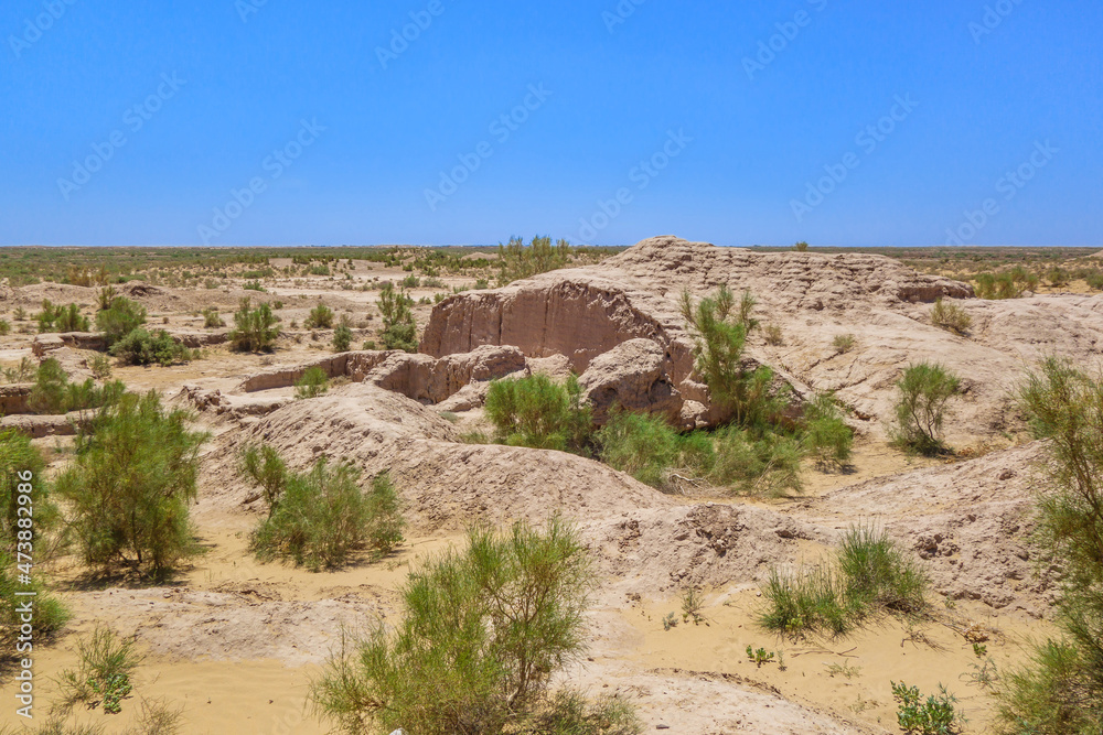 Residential buildings of the Ayaz-Kala fortress, almost disappeared in mists of time and covered with sands and desert bushes. Shot in Kyzylkum desert, Karalpakistan (Uzbekistan)