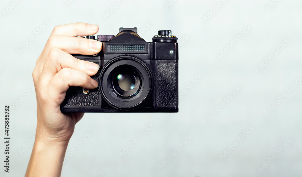 Close-up camera in hand, on white background