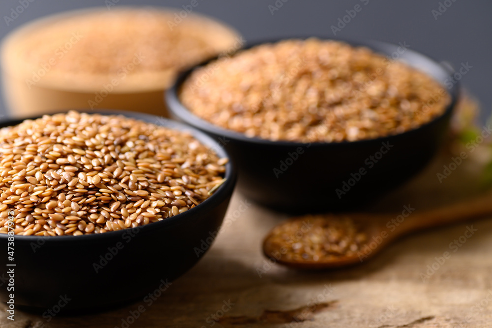 Close up of golden flax seed in bowl on wooden background Close up of golden flax seed in bowl on wooden background