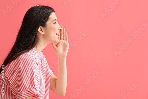 Young gossiping woman on color background