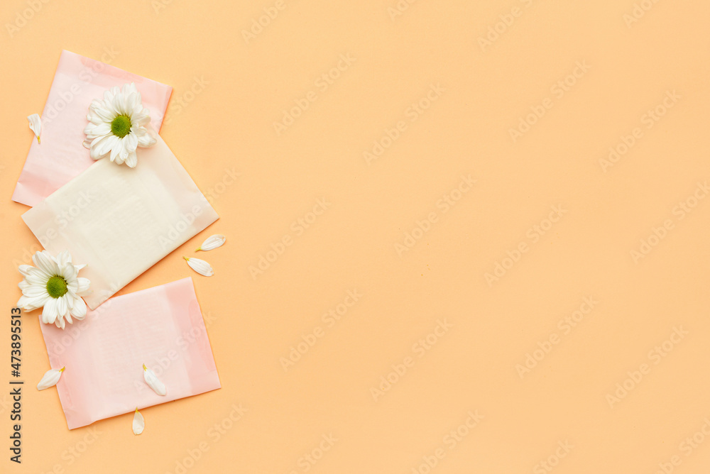 Flowers and menstrual pads on color background Flowers and menstrual pads on color background