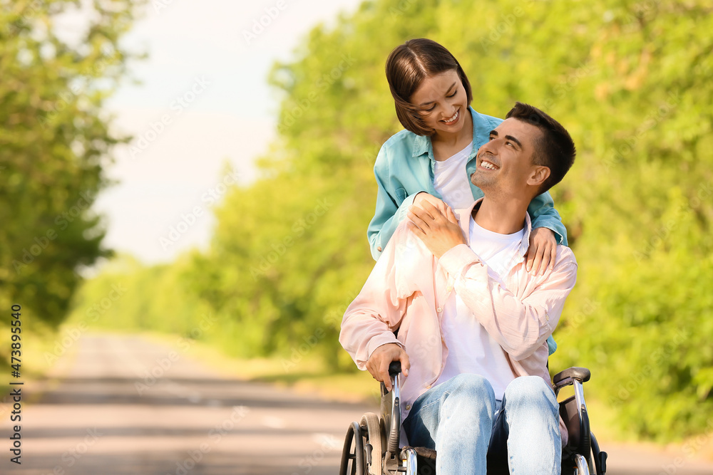 Young man with physical disability and his wife outdoors Young man with physical disability and his wife outdoors