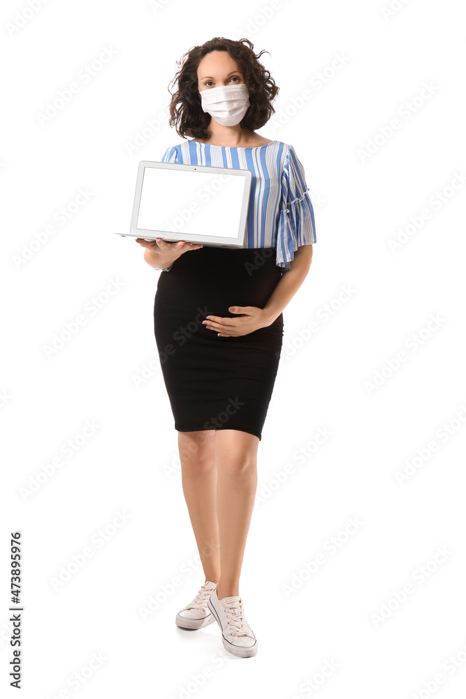 Young pregnant woman in medical mask with laptop on white background Young pregnant woman in medical mask with laptop on white background