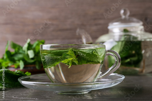 Cup of mint tea on table