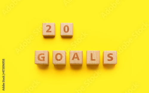 Wooden cubes with figure 20 and word GOALS on yellow background