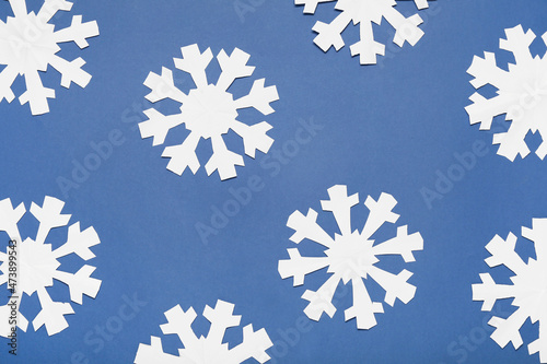 Beautiful paper snowflakes on blue background