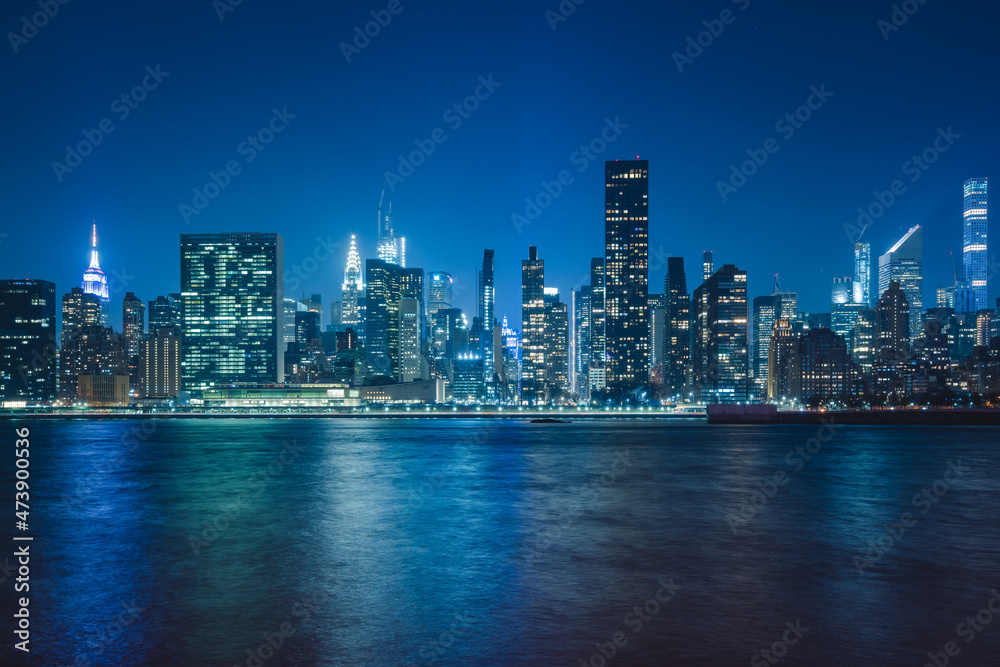panoramic view new york city skyline at night with dense buildings and skyscrapers