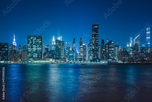 panoramic view new york city skyline at night with dense buildings and skyscrapers