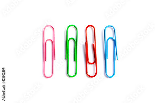 olorful paper clips on white background with copy space.