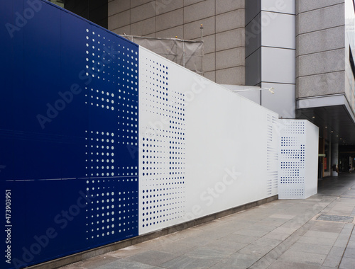 Blank empty construction hoarding space for advertisement mockup. Construction site area in the CBD. photo
