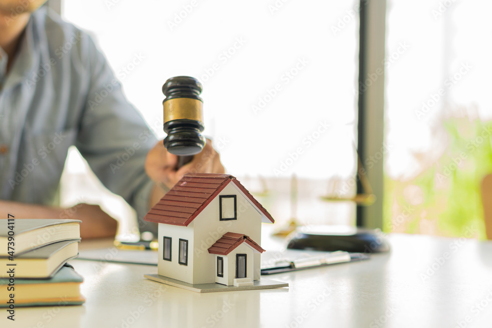 Home dealers hold a hammer on the idea of a real estate court ruling or property auction. Home dealers hold a hammer on the idea of a real estate court ruling or property auction.