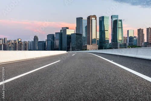 Panoramic skyline and modern commercial office buildings with empty road. Asphalt road and cityscape.