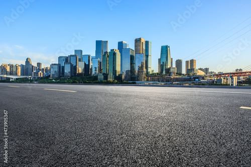 Panoramic skyline and modern commercial office buildings with empty road. Asphalt road and cityscape.