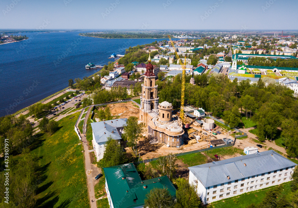Aerial view of Kostroma city on bank of Volga River overlooking Temple Complex of Kostroma Kremlin during reconstruction, Russia