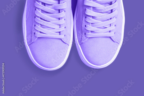 Female sneakers fashion trend color 2022 Very Peri close-up, top view.