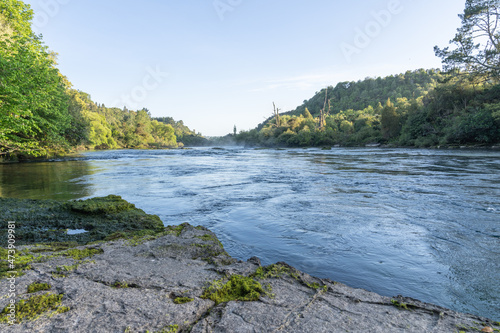 Light mist in distance as sun rises over Waikato River near Huka Falls.