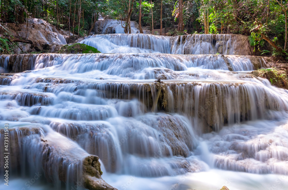 Fototapeta premium Erawan waterfalls in the national park mountains of Kanchanaburi BKK Bangkok Thailand lovely turquoise blue creamy waters lush green trees smooth rock formations