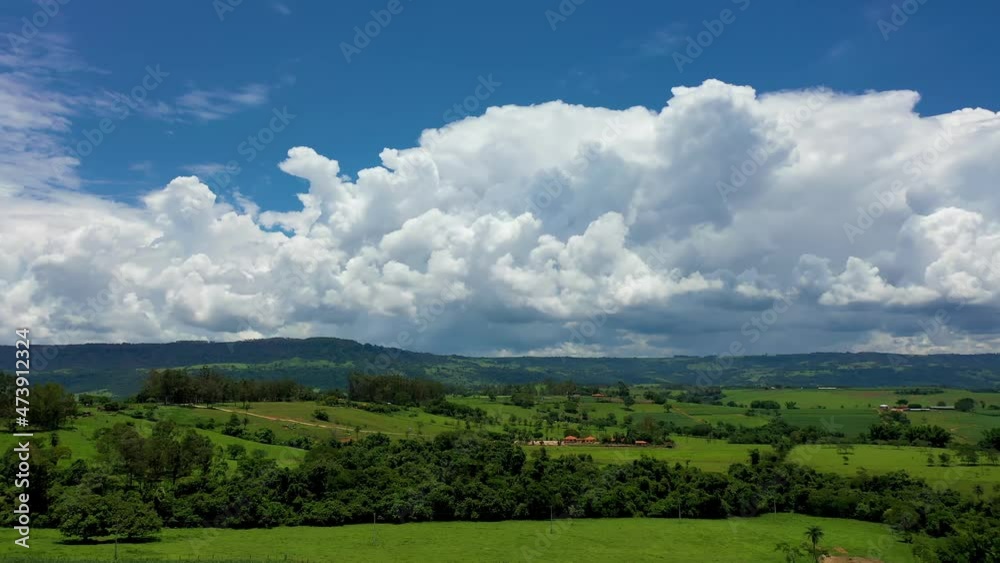 Panorama view of rural landscape. Countryside scenery aerial view. Tropical scenery. Plantation agriculture field. Green background. Brazilian agribusiness. Panorama view of rural landscape. Countryside scenery aerial view. Tropical scenery. Plantation agriculture field. Green background. Brazilian agribusiness.