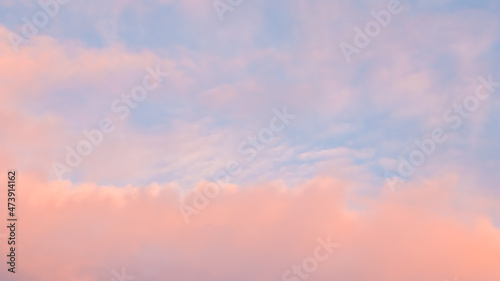 Background of blue sky with pale pink clouds in sunset