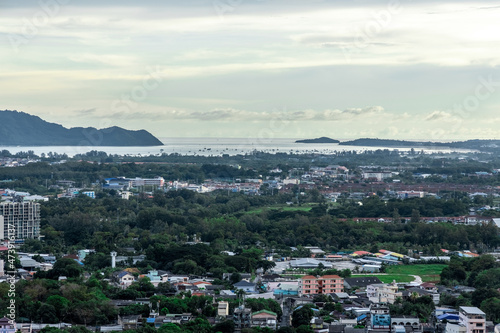Panoramic view old phuket town viewed from Khaorang Hill and in the distance is Challong Bay and the islands big Buddha and Rawai Phuket Thailand © Elias Bitar