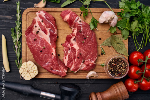 meat on wooden board vegetables and ingredients for cooking wooden background