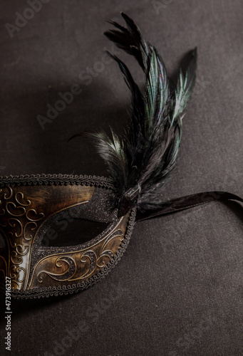 Fotografi Carnival Venetian mask with feathers on black color background, female disguise,
