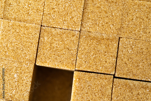 Brown sugar cubes used to sweeten drinks and beverages photo