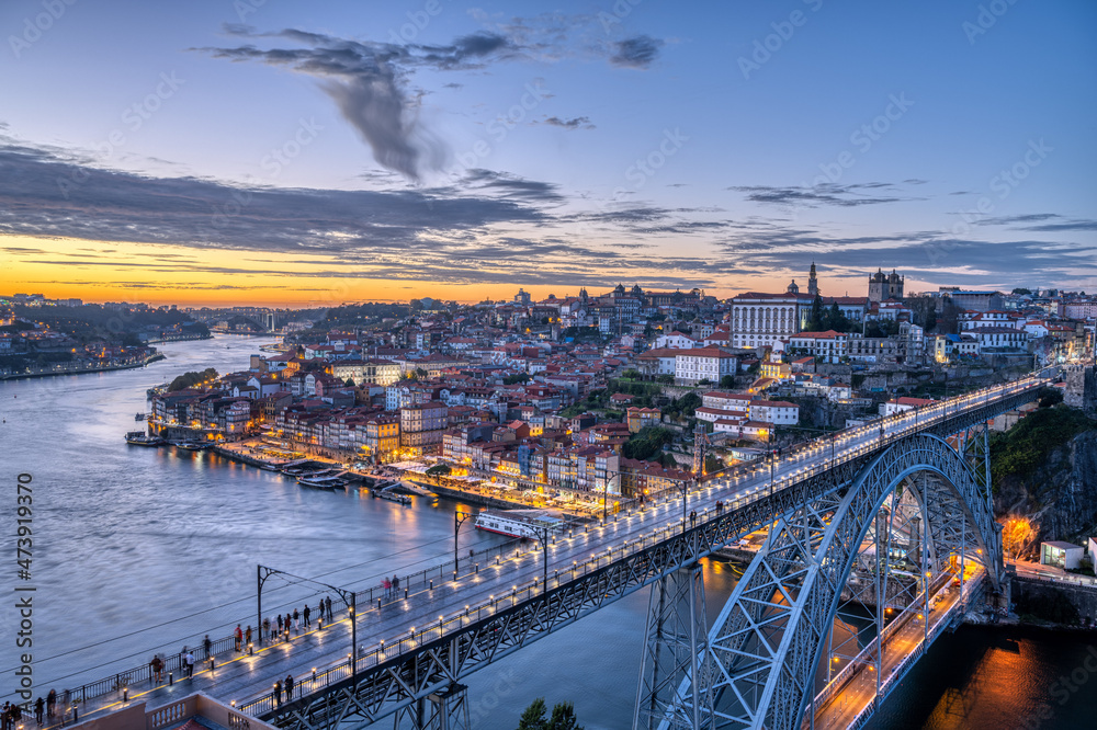 View of Porto with the famous iron bridge and the river Douro after sunset