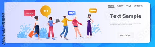 mix race friends using laptops social media chat bubble communication concept full length horizontal