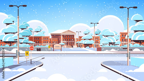snowy school building empty front yard with snow winter cityscape background