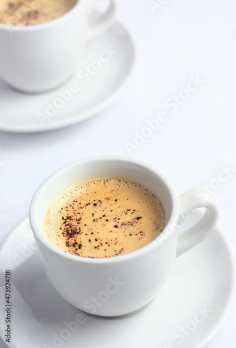 Freshly brewed coffee in a white mug on the table. Breakfast.