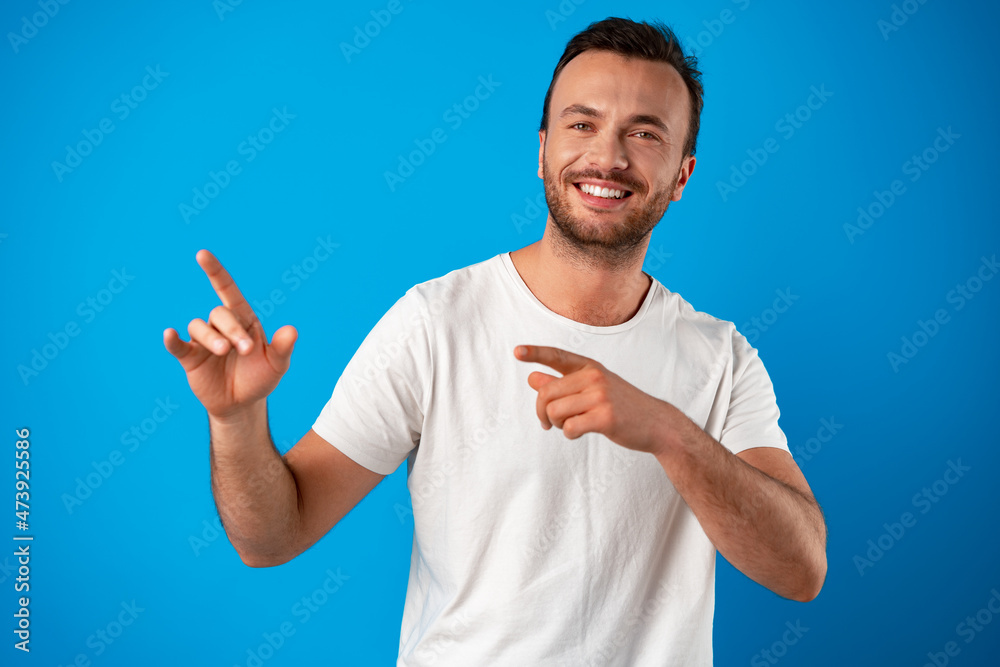 Male customer presenting new product, pointing finger at copy space Male customer presenting new product, pointing finger at copy space