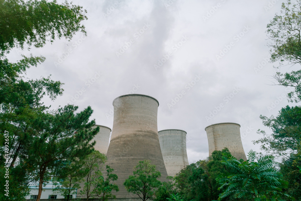 The cooling tower of the factory built next to the green space The cooling tower of the factory built next to the green space