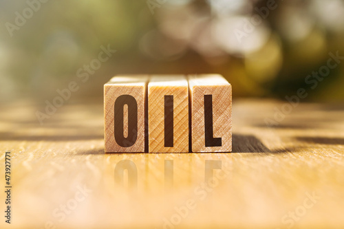 word OIL on cube blocks on light background