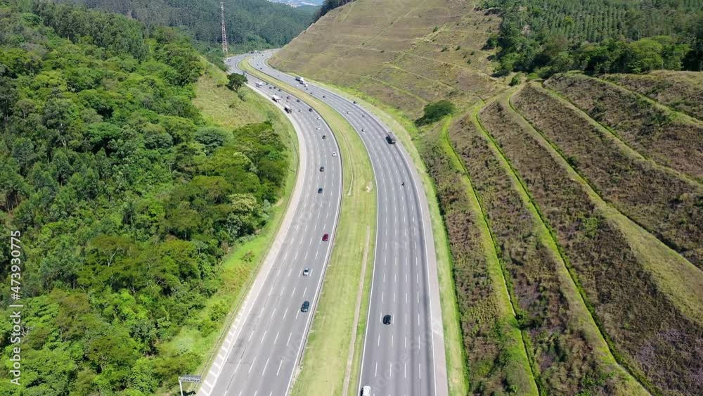 Aerial landscape of Bandeirantes highway road at countryside of Sao Paulo state Brazil. Landmark highway road between mountains. Rural landscape. Traffic at road. Brazilian freeway road. Aerial landscape of Bandeirantes highway road at countryside of Sao Paulo state Brazil. Landmark highway road between mountains. Rural landscape. Traffic at road. Brazilian freeway road.