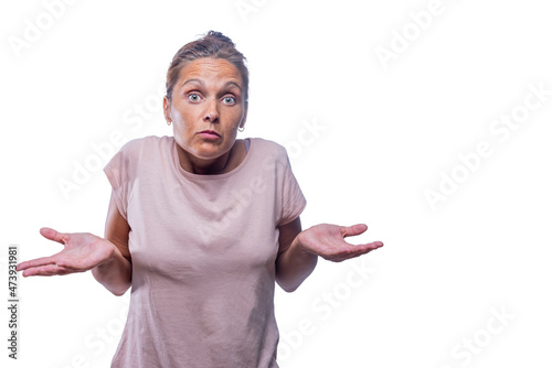 An adult woman looks doubtfully on a white background photo