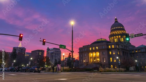 Unbelievable sunset in Downtown Boise Idaho, overlooking the Idaho State Capitol Building with traffic passing by. Taken in December 2021 with Christmas tree light up on one of the buildings. photo