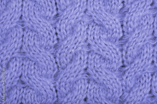 Cozy background of violet knitted texture