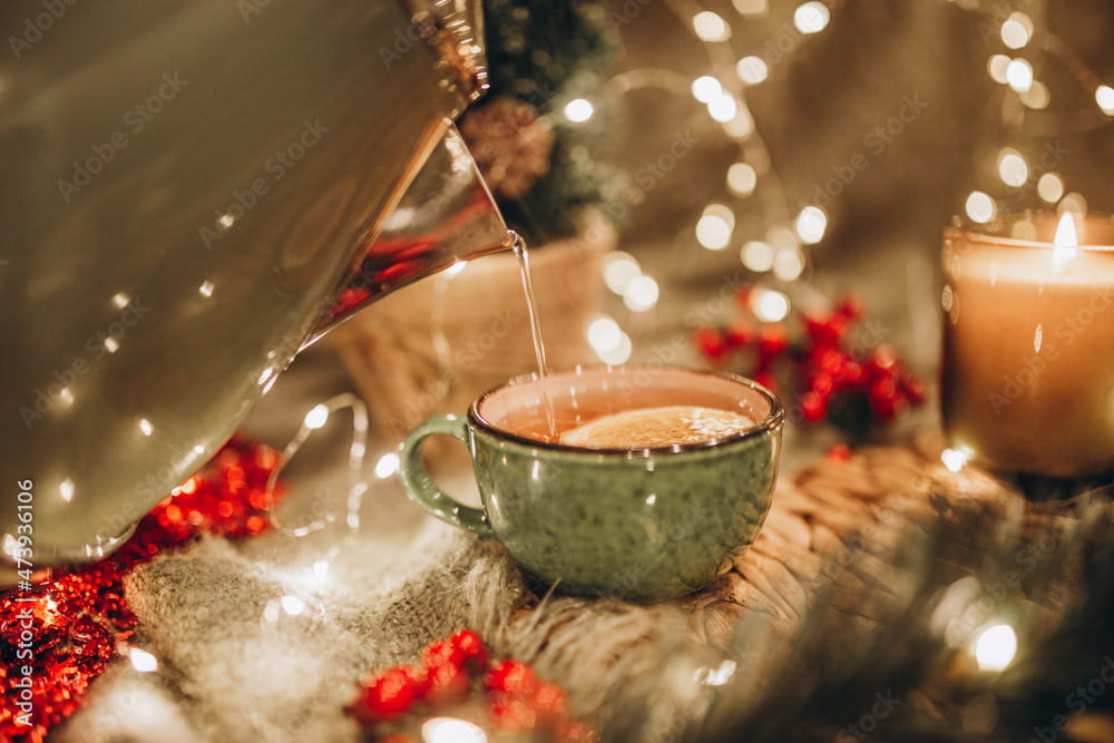 evening tea party with Christmas lights hot tea and candy StockFoto