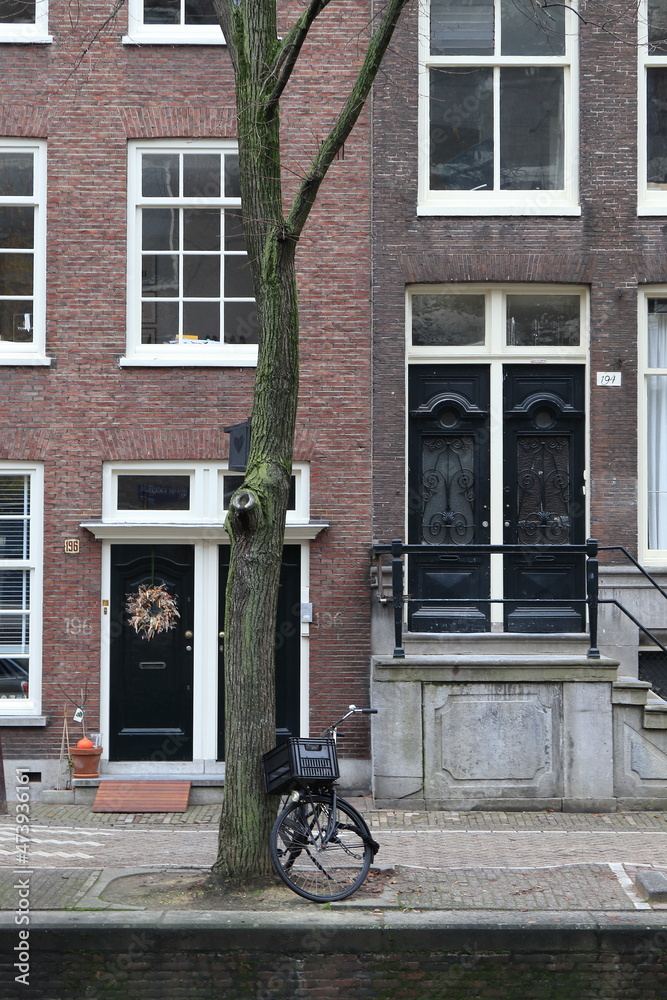 Amsterdam Canal Street View Close Up with House Entrance, Christmas Wreath, Tree and Parked Bicycle, Netherlands