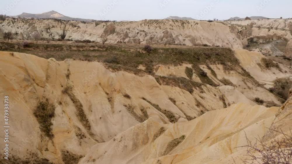 Amazing panning landscape with sand rock valley. Beautiful panoramic view of natural valley with sandy hills and rocks at cloudy day