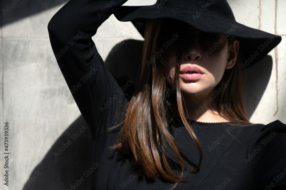 Beautiful woman in hat in fashionable summer spring clothes outdoors. Female stylish model walking city street. Summer trend, fashion outfit. Beautiful woman in hat in fashionable summer spring clothes outdoors. Female stylish model walking city street. Summer trend, fashion outfit.