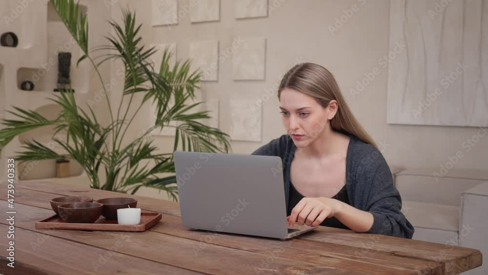 Young caucasian woman sad, stressful work laptop at home wooden warm apartment Young caucasian woman sad, stressful work laptop at home wooden warm apartment