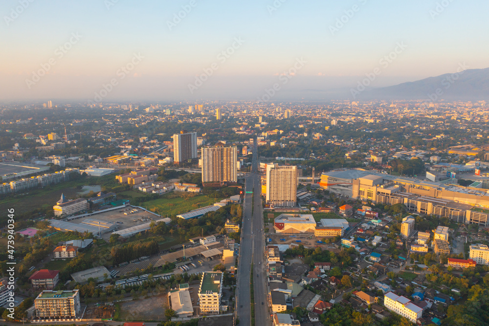 Fototapeta premium Aerial view of Chiang Mai Downtown Skyline, Thailand. Financial district and business centers in smart urban city in Asia. Skyscraper and high-rise buildings at sunset.