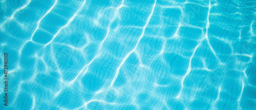 Beautiful relaxing swimming pool water sun reflection background. Ripple water texture background, natural sunlight. Abstract artistic water surface background
