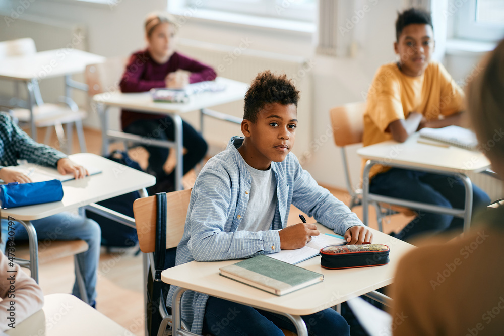 African American elementary student and his classmates during lecture in the classroom. African American elementary student and his classmates during lecture in the classroom.