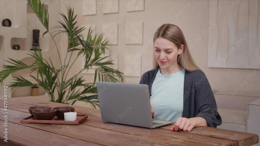 Young caucasian woman happy, joyful work laptop at home wooden warm apartment Young caucasian woman happy, joyful work laptop at home wooden warm apartment